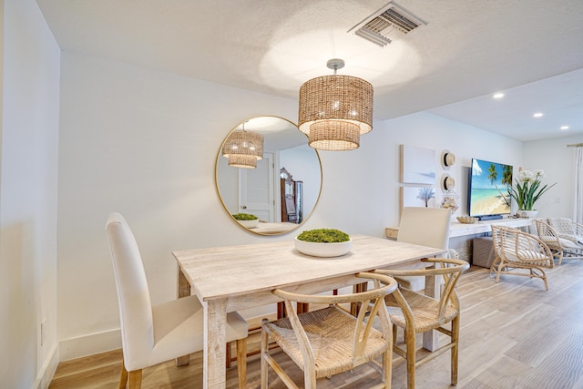 dining space with light wood-type flooring