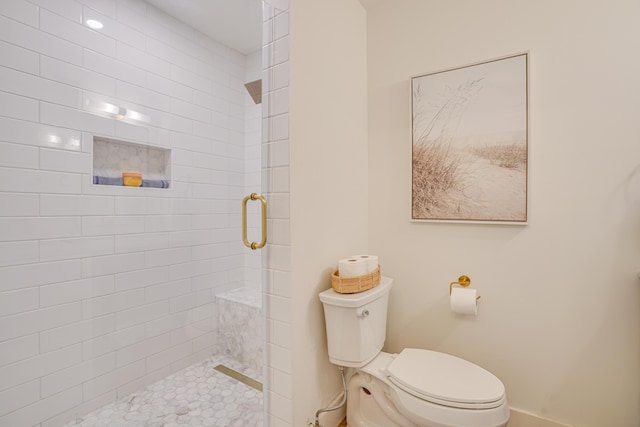 bathroom with toilet and an enclosed shower