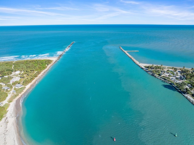 drone / aerial view featuring a water view and a view of the beach