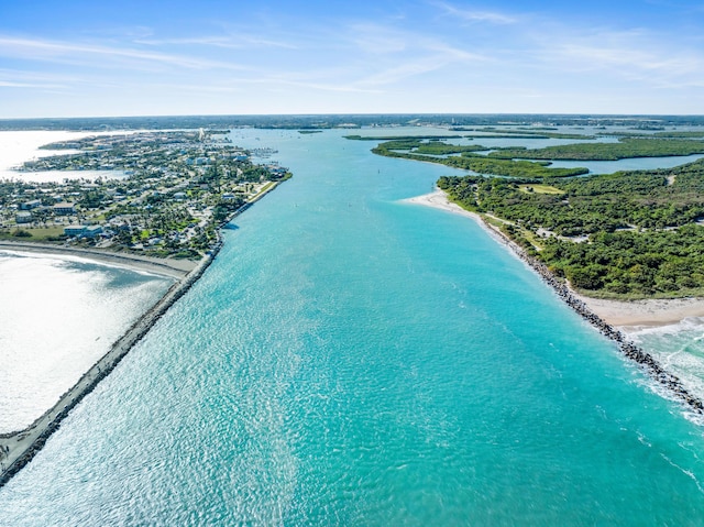 bird's eye view with a water view and a beach view