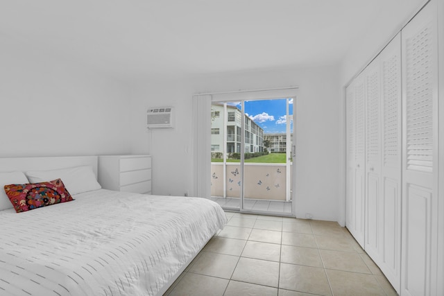 bedroom with light tile patterned floors and a wall unit AC