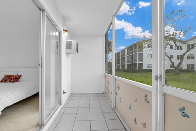 balcony with an AC wall unit and french doors