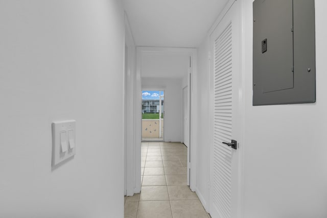 hallway with light tile patterned floors and electric panel