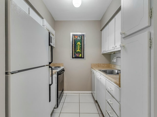 kitchen featuring white cabinets, light tile patterned floors, white appliances, and sink