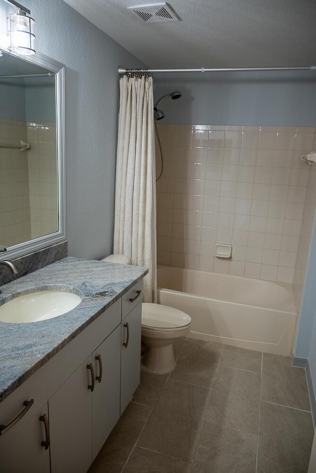 full bathroom with vanity, toilet, tile patterned flooring, and shower / tub combo