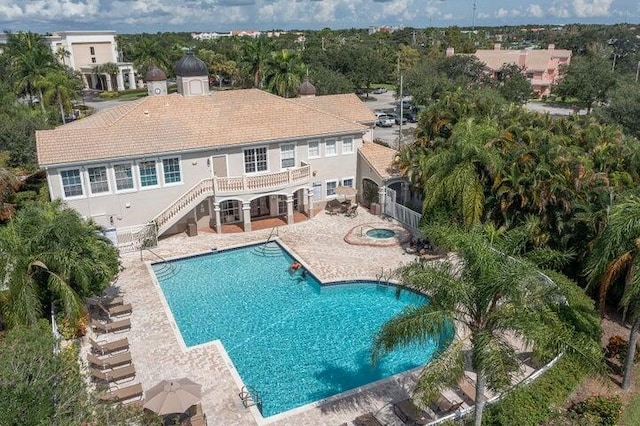 view of swimming pool featuring a hot tub and a patio