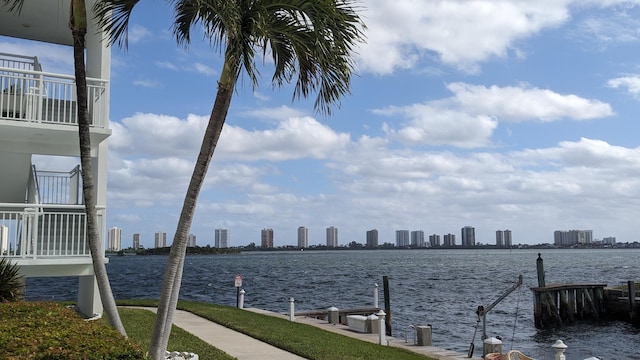 property view of water with a dock and a city view