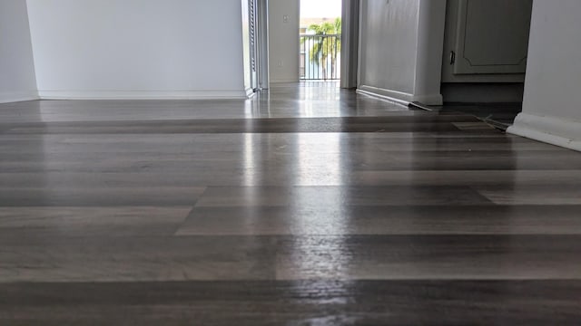 empty room featuring wood finished floors and baseboards