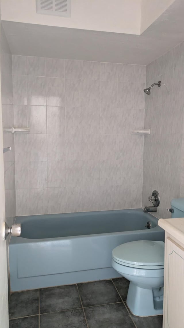 bathroom featuring toilet, shower / bath combination, vanity, visible vents, and tile patterned floors