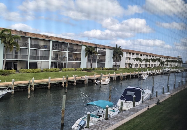 dock area with a yard and a water view