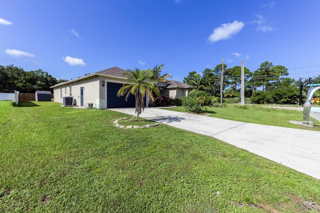 view of front of home featuring a front yard, a garage, and central air condition unit