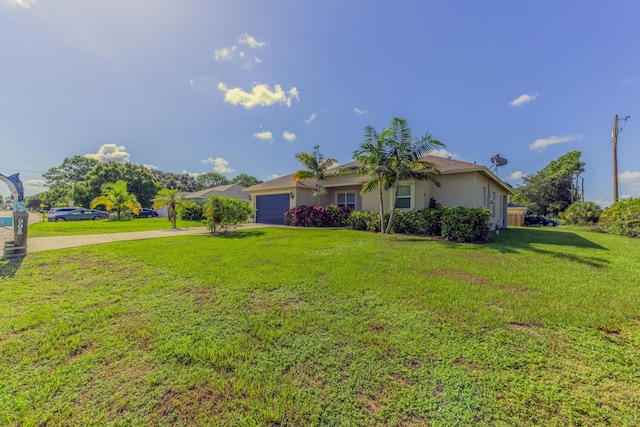 view of front of home with a front yard and a garage