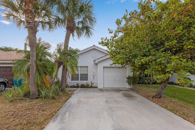 view of front of home featuring a front yard and a garage