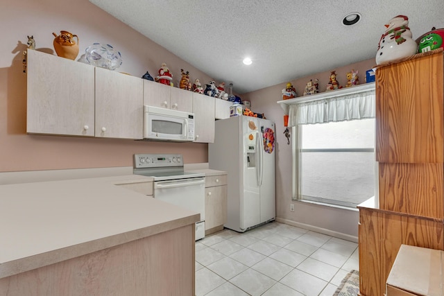 kitchen featuring white appliances, a textured ceiling, light tile patterned floors, and vaulted ceiling