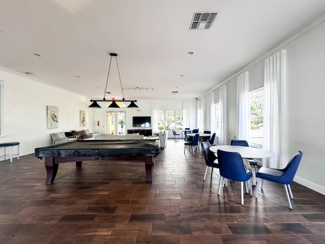 recreation room with ornamental molding, dark wood-type flooring, a healthy amount of sunlight, and billiards