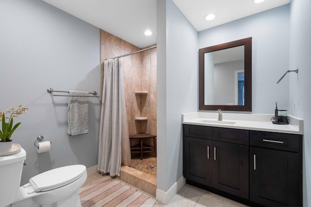 bathroom with tile patterned floors, a shower with curtain, vanity, and toilet