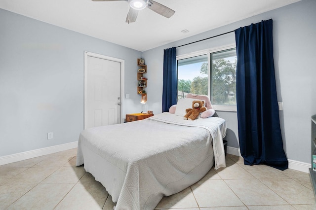 bedroom with ceiling fan and light tile patterned floors