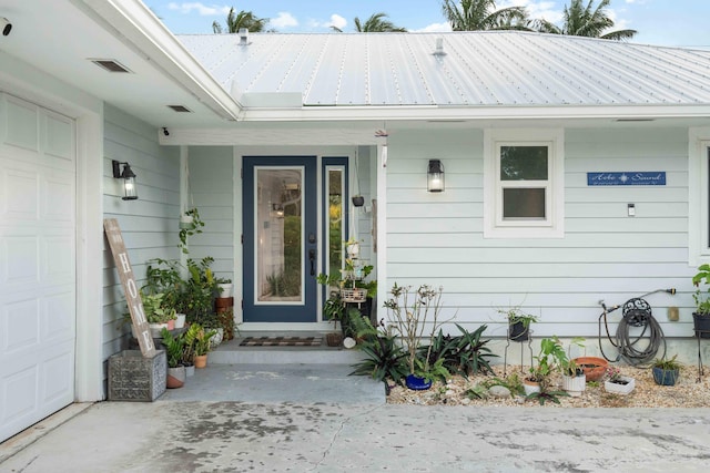 doorway to property with a garage