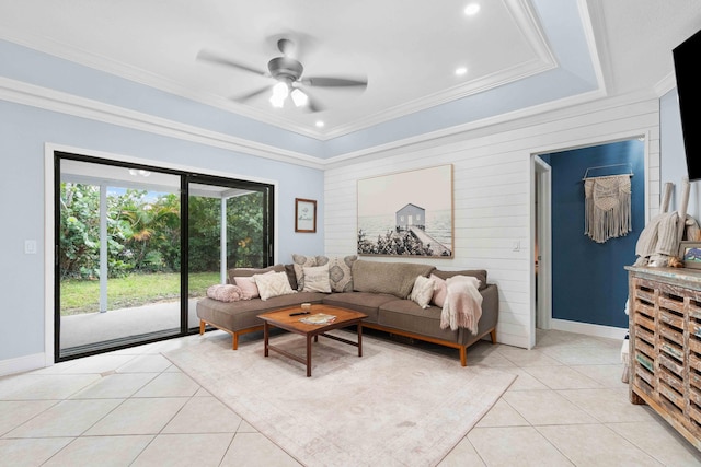 tiled living room featuring ceiling fan, crown molding, and a tray ceiling