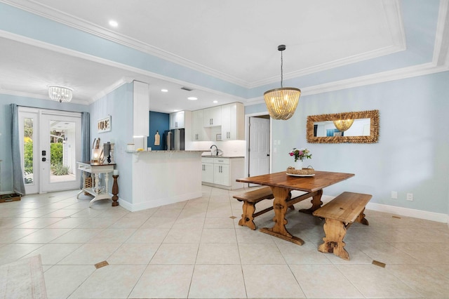 dining space with light tile patterned floors, an inviting chandelier, and ornamental molding