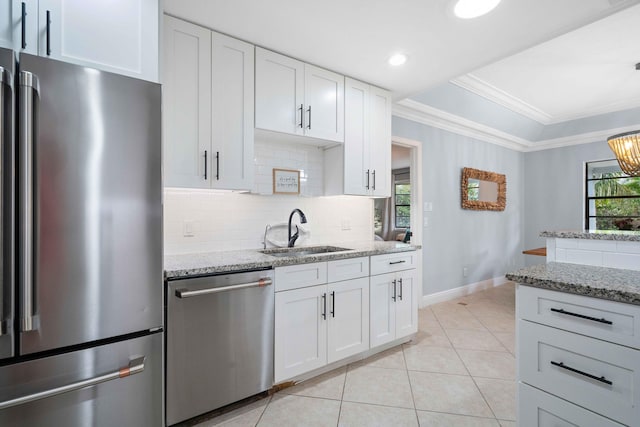 kitchen with light stone countertops, sink, white cabinets, and appliances with stainless steel finishes