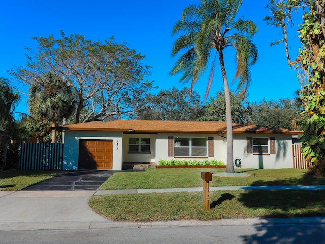 ranch-style home featuring a garage and a front lawn