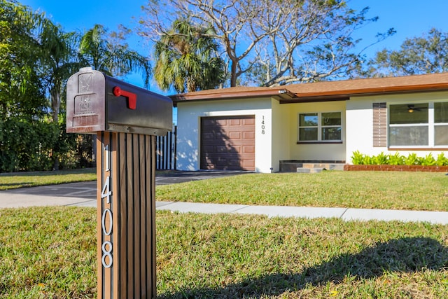 view of front of home featuring a front yard and a garage