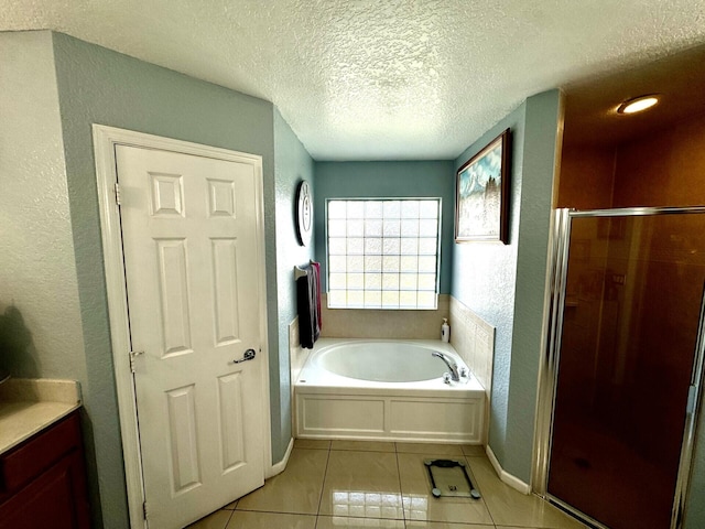 bathroom featuring tile patterned flooring, vanity, a textured ceiling, and shower with separate bathtub