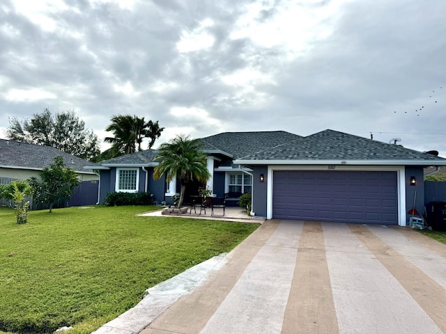 ranch-style home with a front yard, a garage, and a patio area