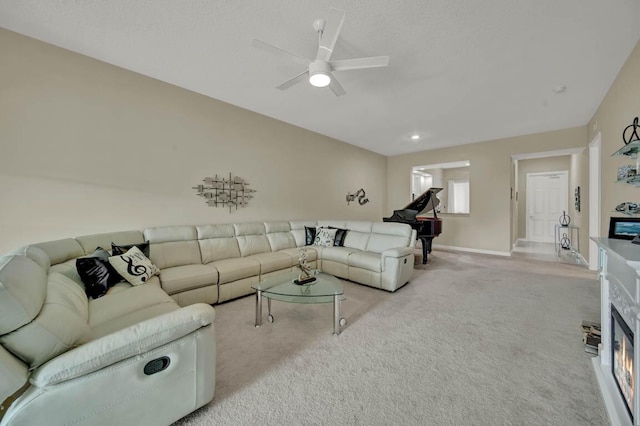 living room with ceiling fan and light colored carpet