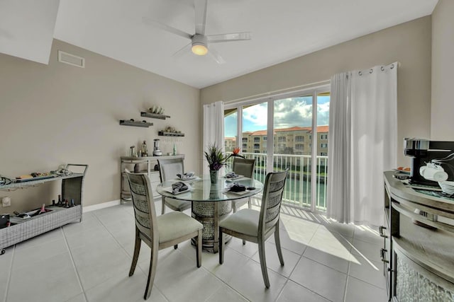 tiled dining space featuring ceiling fan