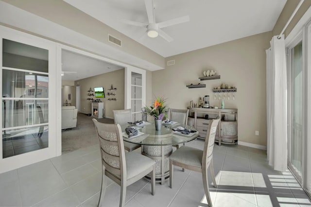 tiled dining space with ceiling fan