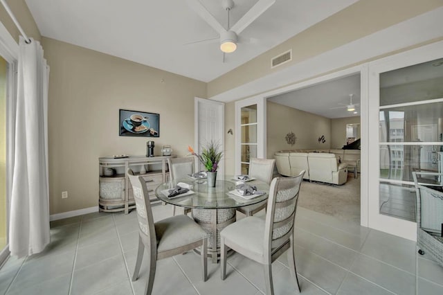 dining space featuring ceiling fan and light tile patterned floors