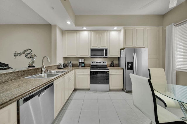 kitchen featuring sink, light tile patterned floors, and stainless steel appliances