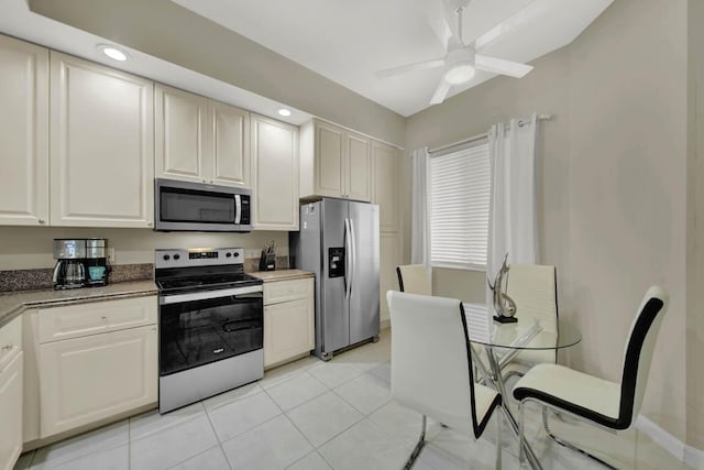 kitchen featuring ceiling fan, light tile patterned flooring, and stainless steel appliances