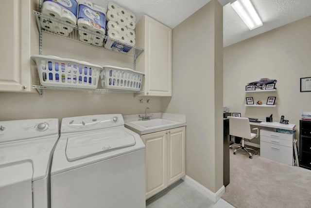 clothes washing area featuring cabinets, light carpet, sink, separate washer and dryer, and a textured ceiling