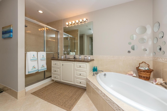 bathroom featuring tile patterned flooring, shower with separate bathtub, and vanity