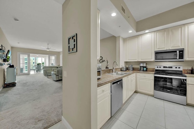 kitchen featuring light carpet, sink, ceiling fan, appliances with stainless steel finishes, and kitchen peninsula