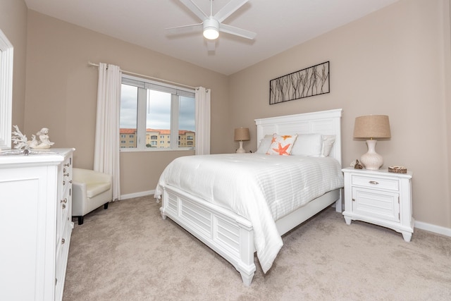 bedroom featuring ceiling fan and light carpet