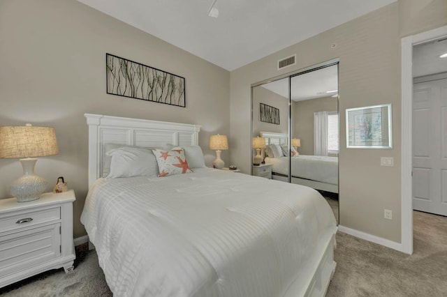 bedroom featuring light colored carpet and a closet