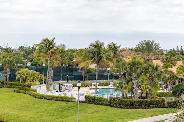 view of home's community featuring a yard and a swimming pool