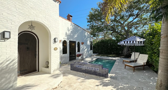 view of patio featuring a fenced in pool