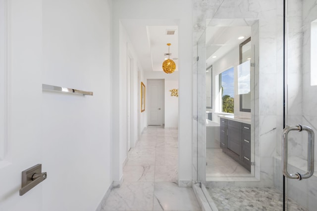 bathroom featuring vanity and a shower with door