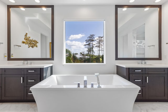 bathroom with a bath and vanity