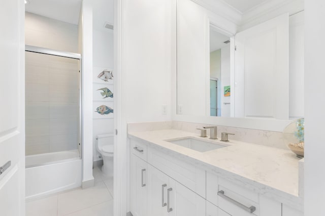 full bathroom with toilet, vanity, tile patterned floors, and tiled shower / bath