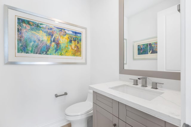 bathroom featuring toilet and vanity