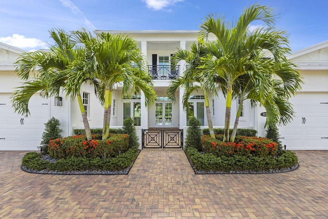 view of front of property with a garage and a balcony