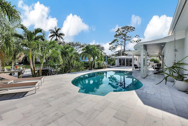 view of swimming pool with a patio