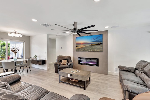 living room featuring light hardwood / wood-style flooring and ceiling fan