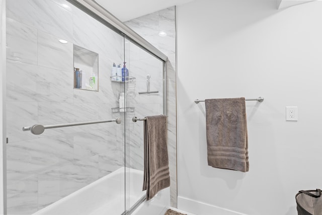 bathroom with shower / bath combination with glass door